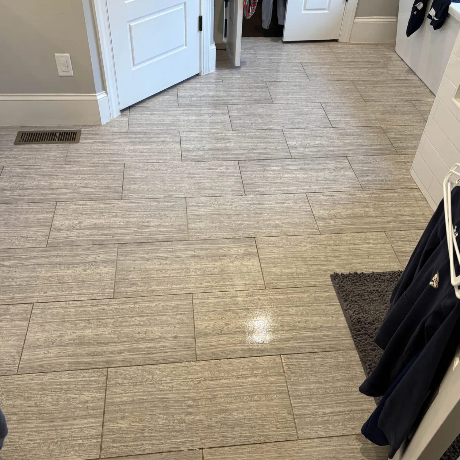 Wood-look plank tile floor in a mudroom entry after grout cleaning